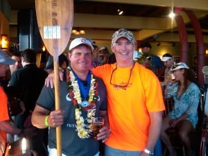 Mark Sandvold is congratulated by Tom McTigue after being the first Hawaii finisher in the 2010 Molokai to Oahu Kayak Race.